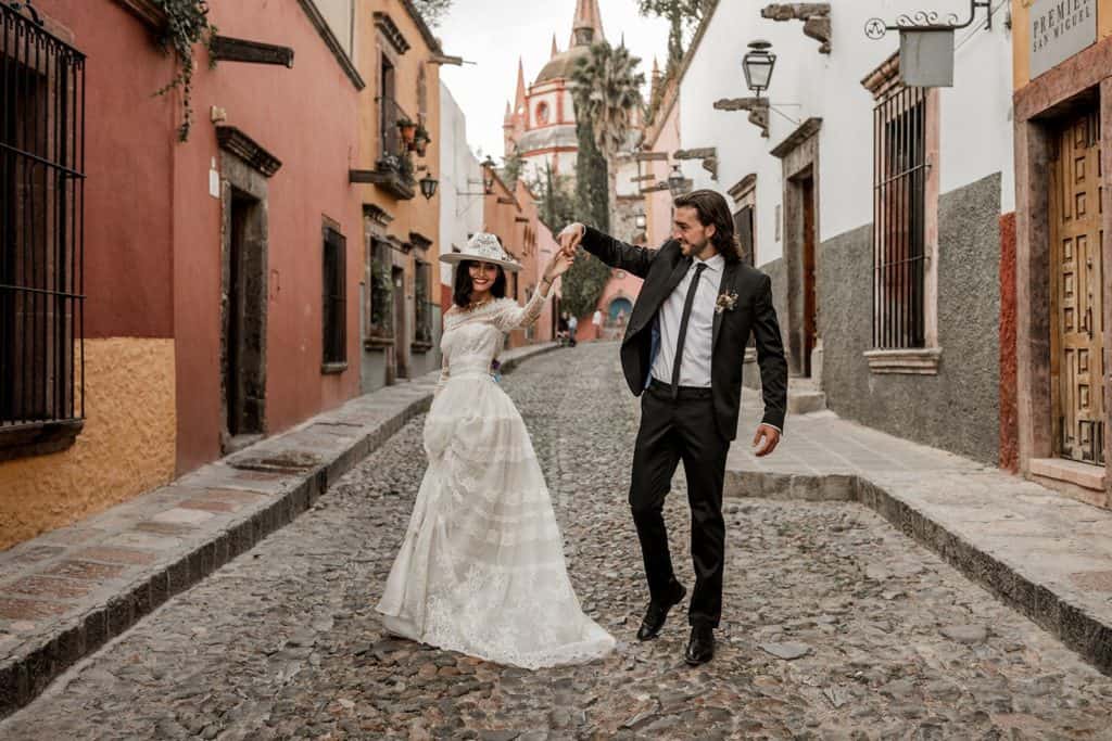 Bride and groom models dance in streets of Mexico during styled shoot