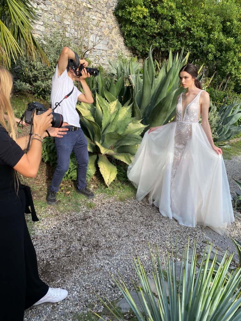 Behind the scenes on a wedding day as a photographer, second shooter, and videographer capture the bride. 