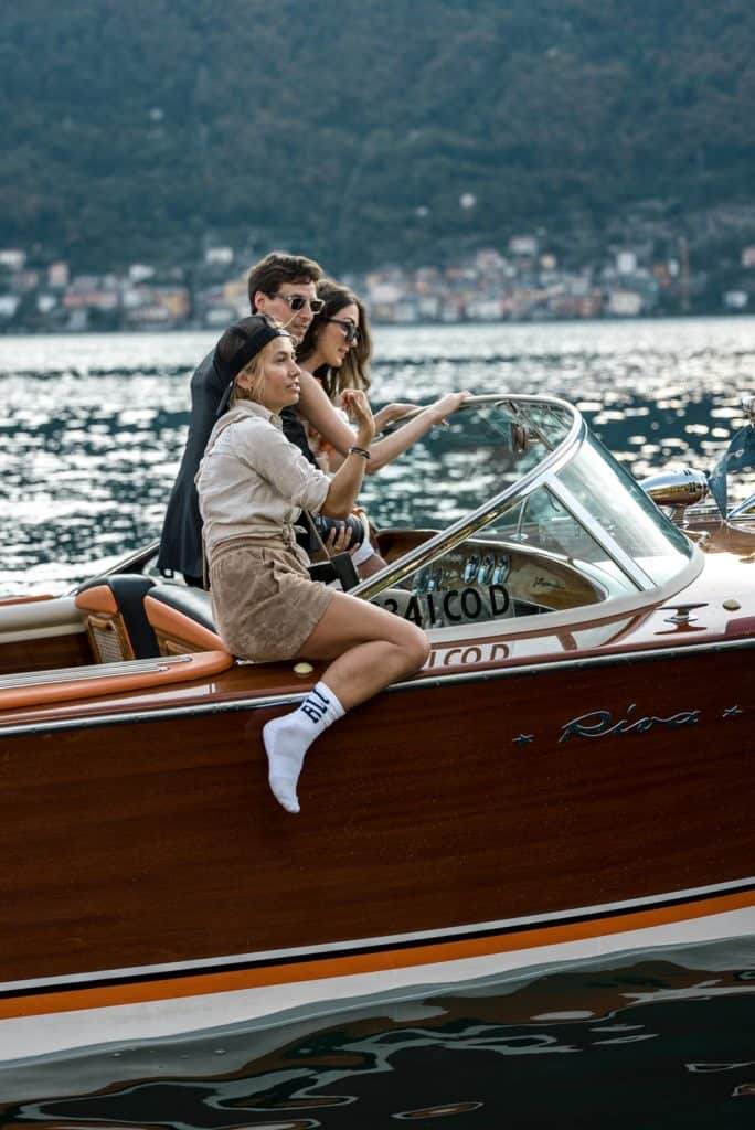 Wedding photographer sits on a boat with bride and groom on Lake Como to capture the shot, as taken by the second shooter