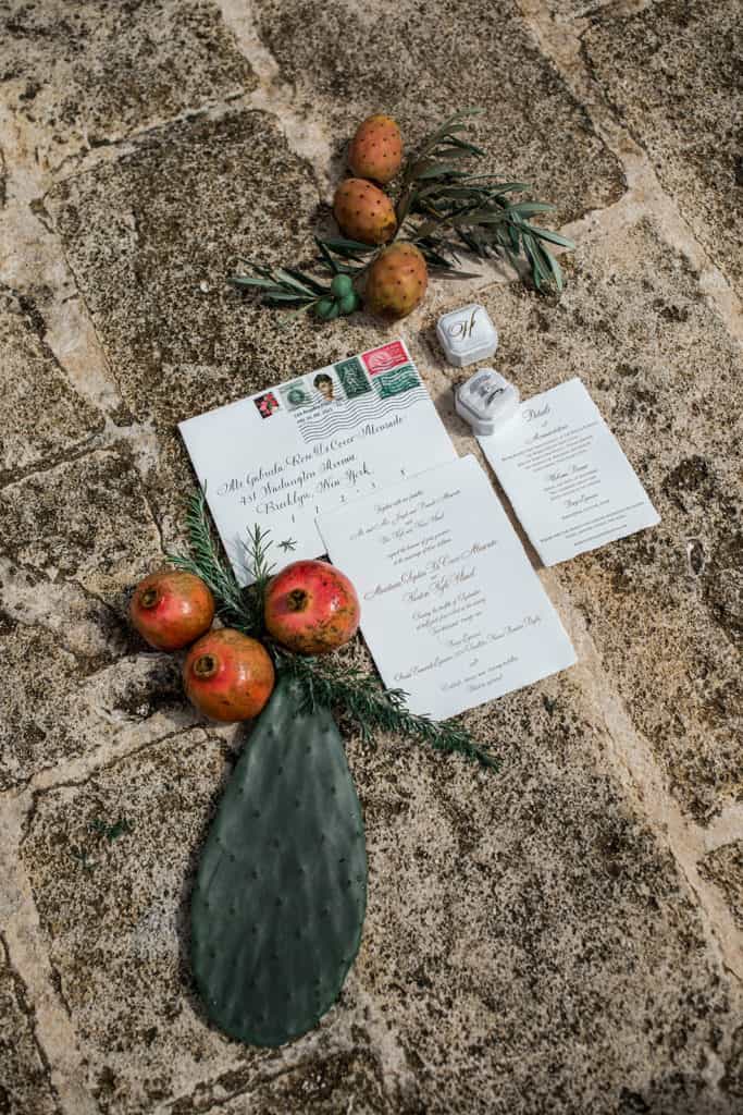 Invitation suite flat lay photography with cactus leaves and fruits from Borgo Egnazia Italy wedding