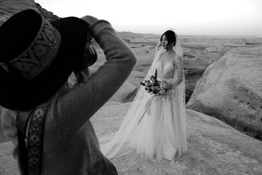 Photographer takes portraits of bride in Amangiri Utah elopement after learning how to attract wedding clients