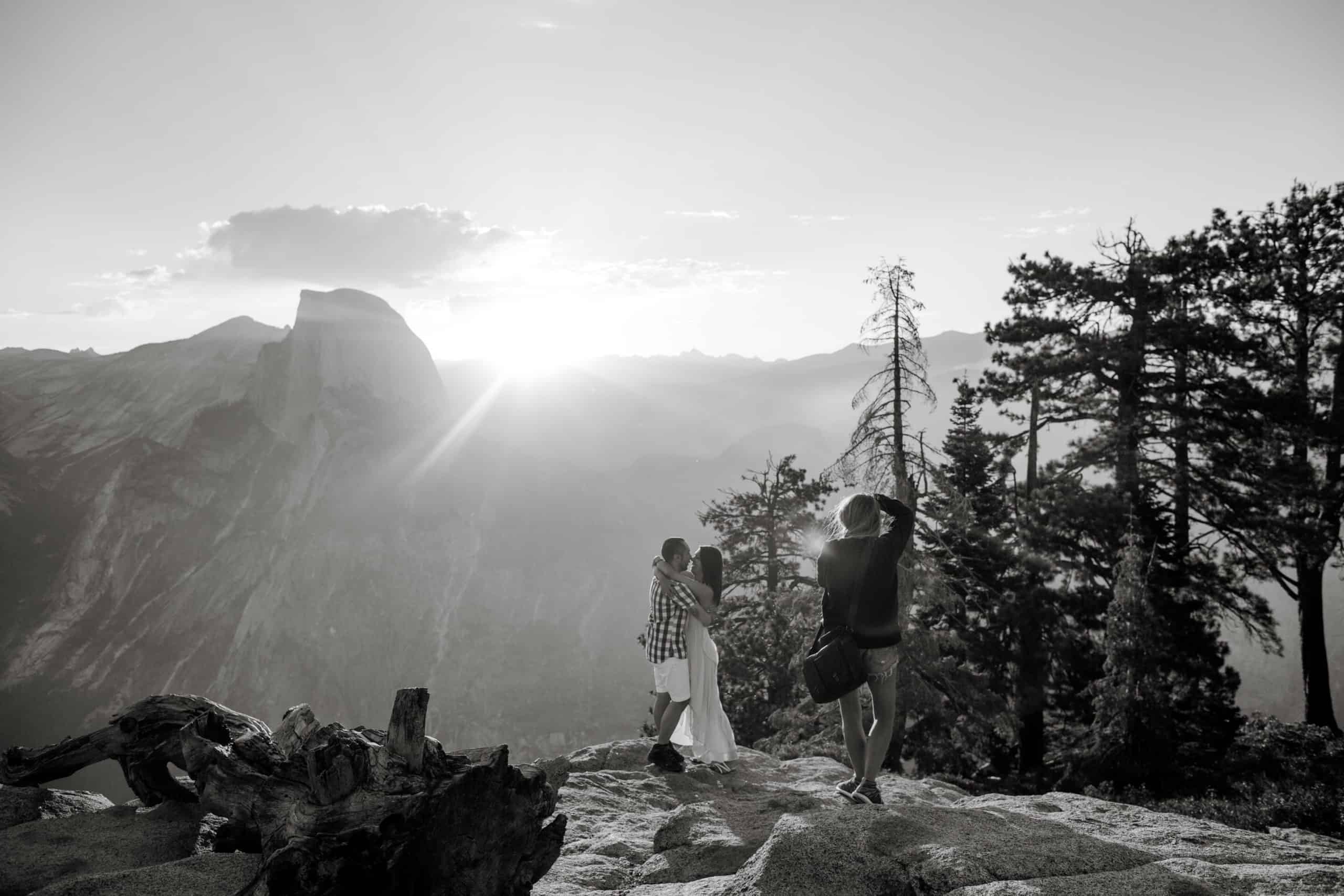 Behind the scenes as Lilly Red, a photography mentor, photographs an engagement on a mountaintop