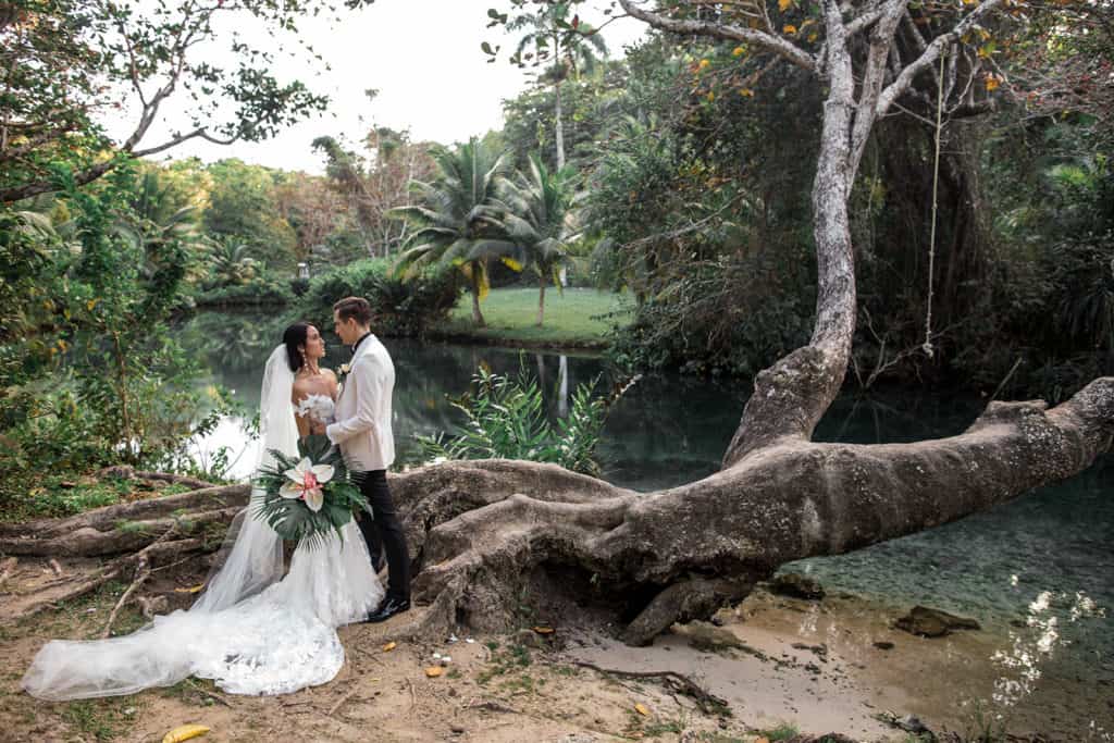 A bride and groom stand together in a destination wedding photograph that was featured in Brides.