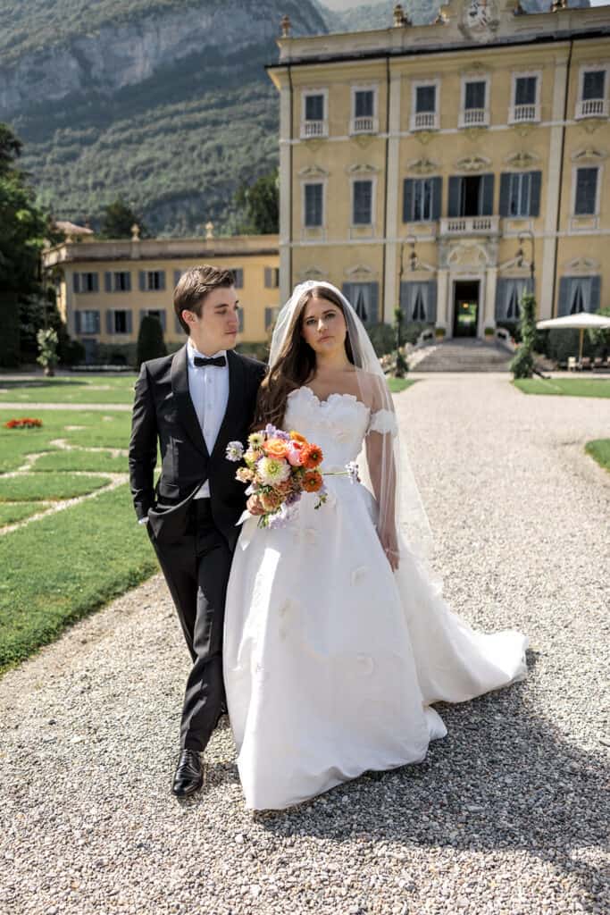 Bride and groom walk outside of Villa Sola Cabiati in Lake Como, Italy
