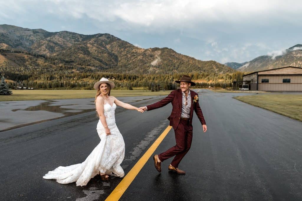 Bride and groom on a private plane runway at an epic wedding venue in Wyoming