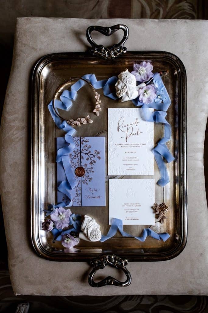 Lavender invitation details on silver tray for wedding flat lay photography