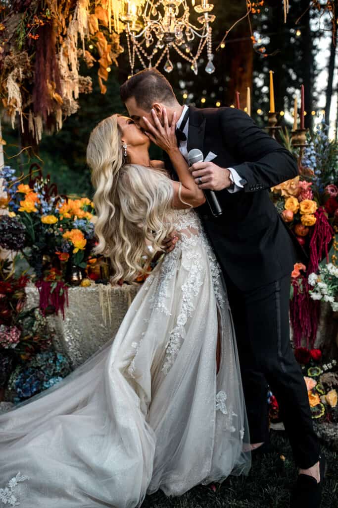 Bride and groom kiss after groom's speech at wedding reception