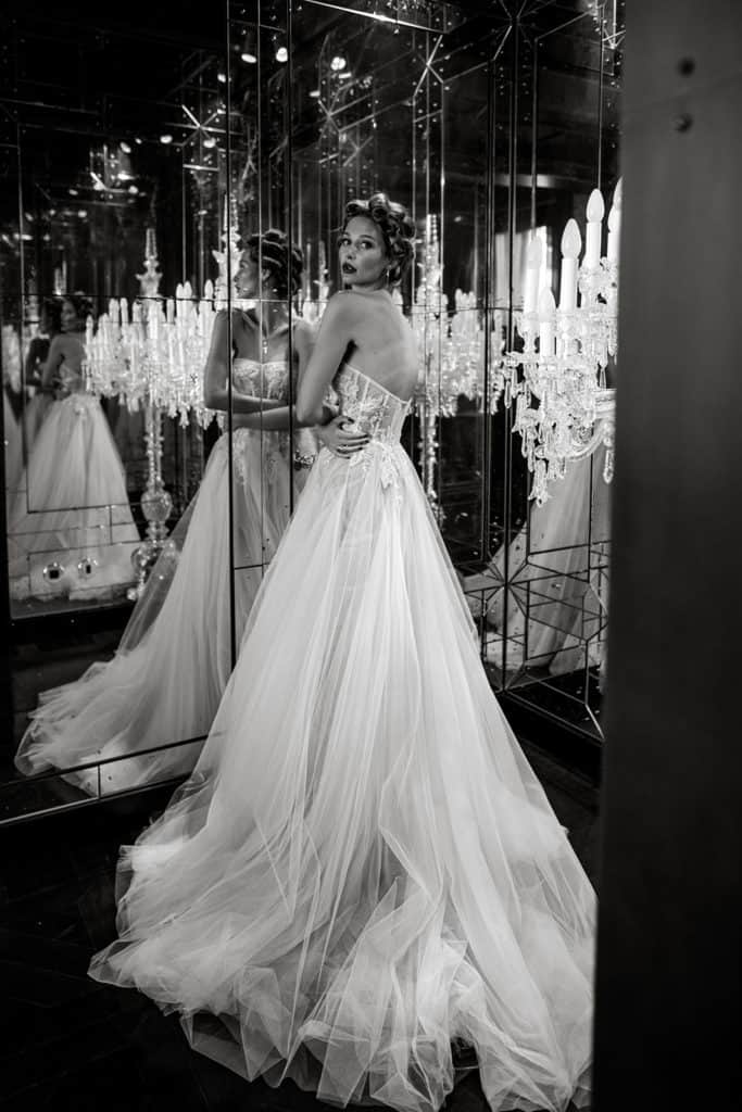Bride wearing Berta wedding gown in front of mirrors is a dramatic portrait, perfect as a Vogue wedding submission
