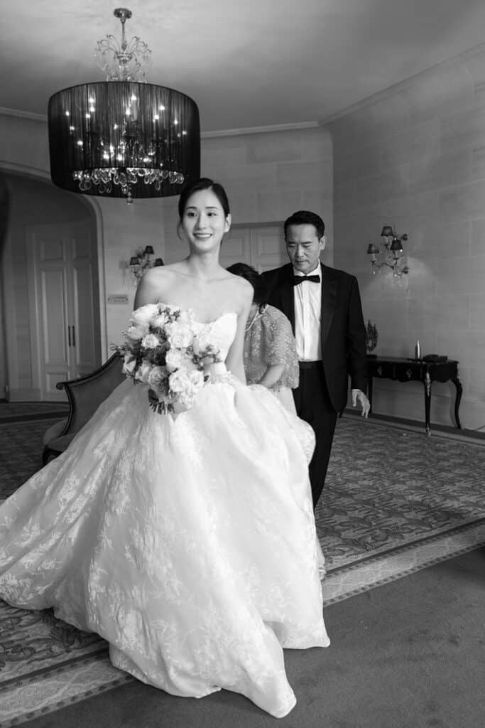 Bride and her father getting ready, captured by wedding photographer who focuses solely on weddings after learning how to outsource for photographers